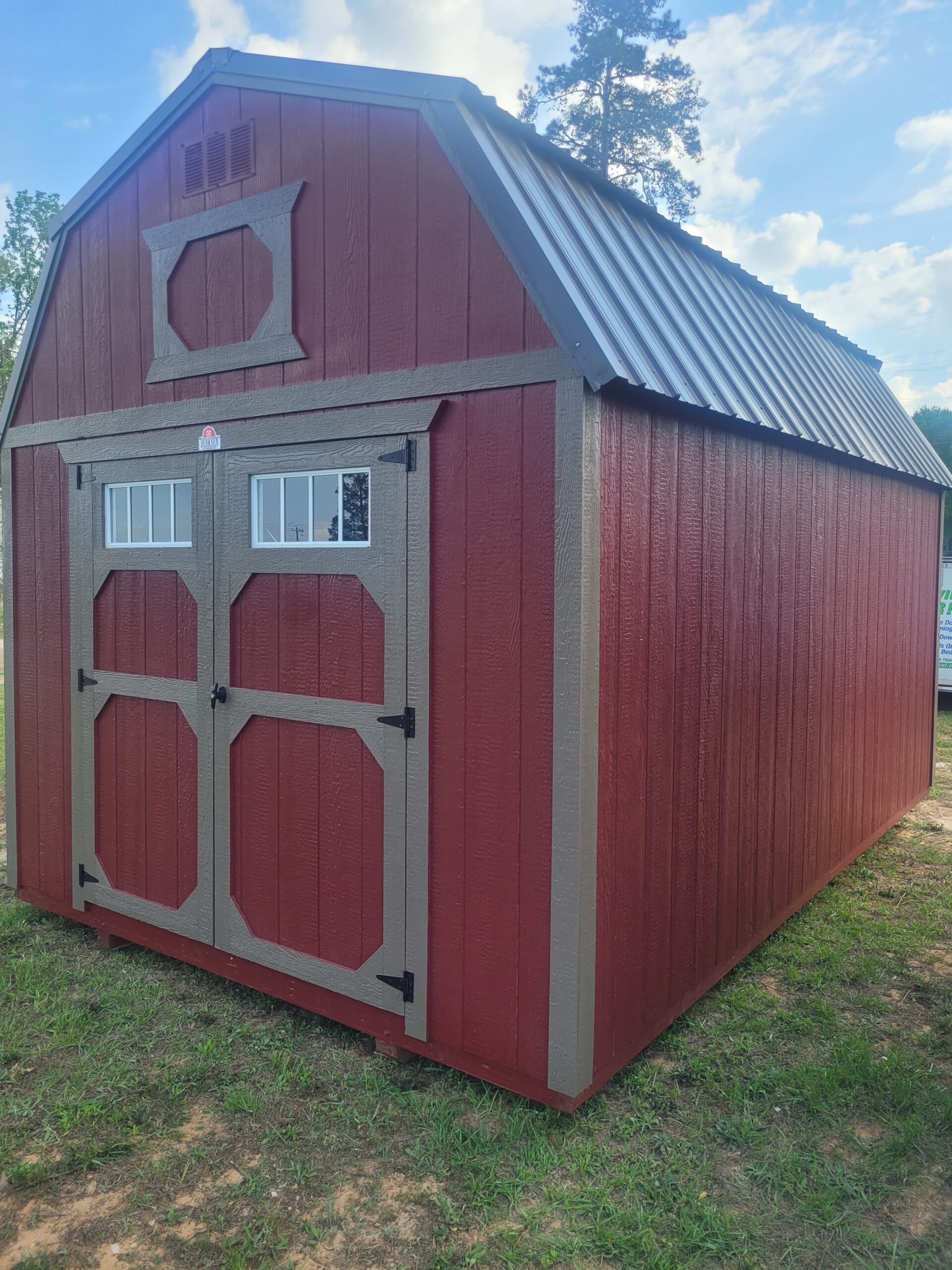Portable barn organized with shelving, tools, and lawn equipment in clean layout