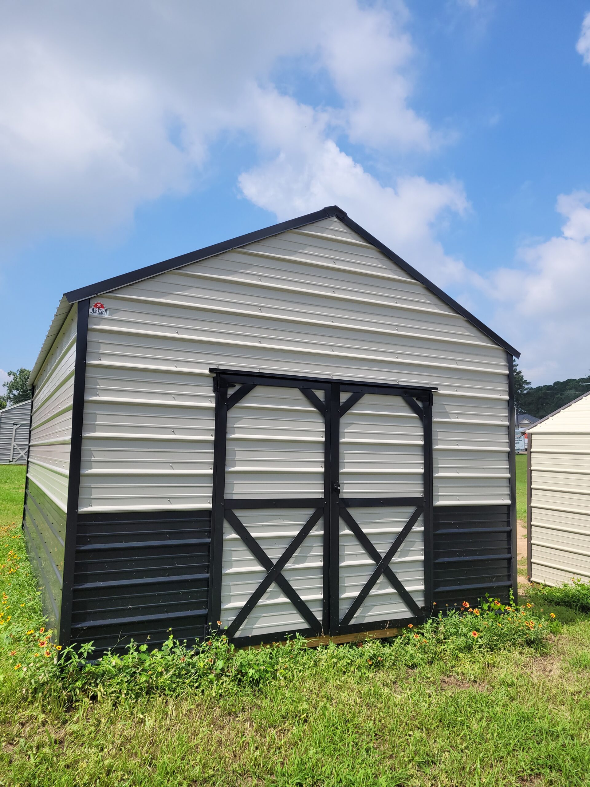 Well-organized utility building interior with shelving, tools, and protected equipment storage