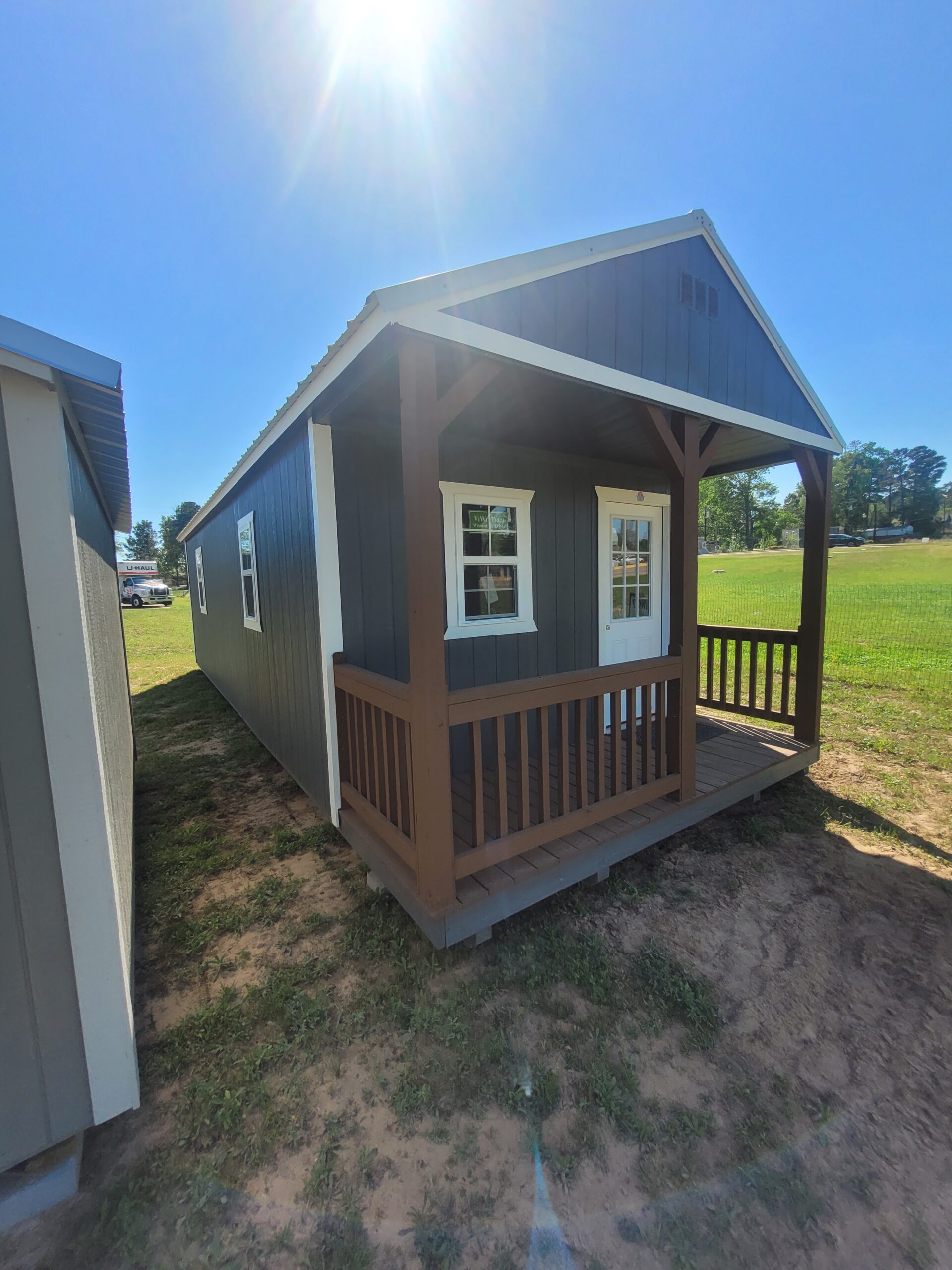 Rustic recreational building arranged for guest stays, hobbies, and comfortable private use, Skilled Shed Builder checking framing alignment during custom storage shed construction