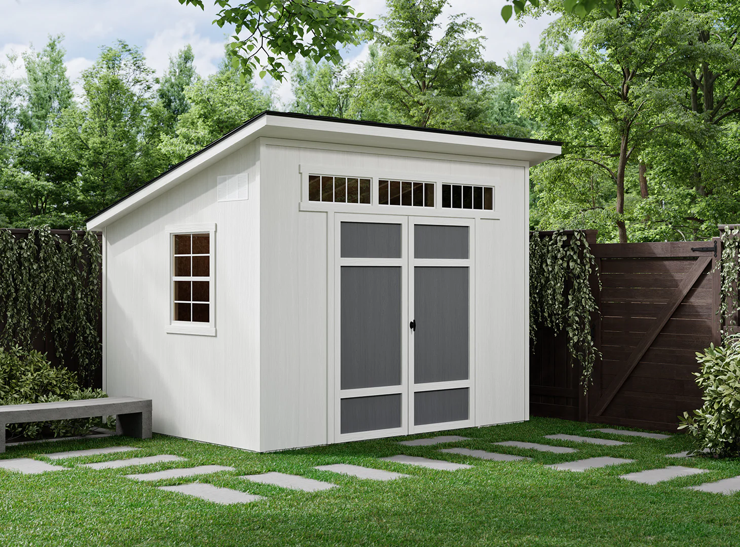 Backyard shed installed beside driveway for tools, mower, and seasonal storage access