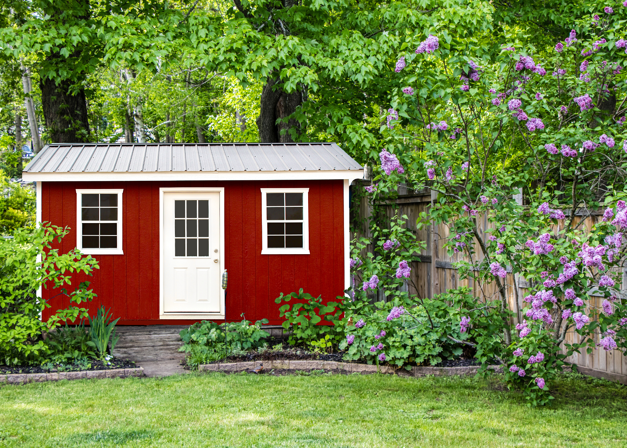 Backyard rustic cabin prepared for weekend guests with porch seating and shaded entry