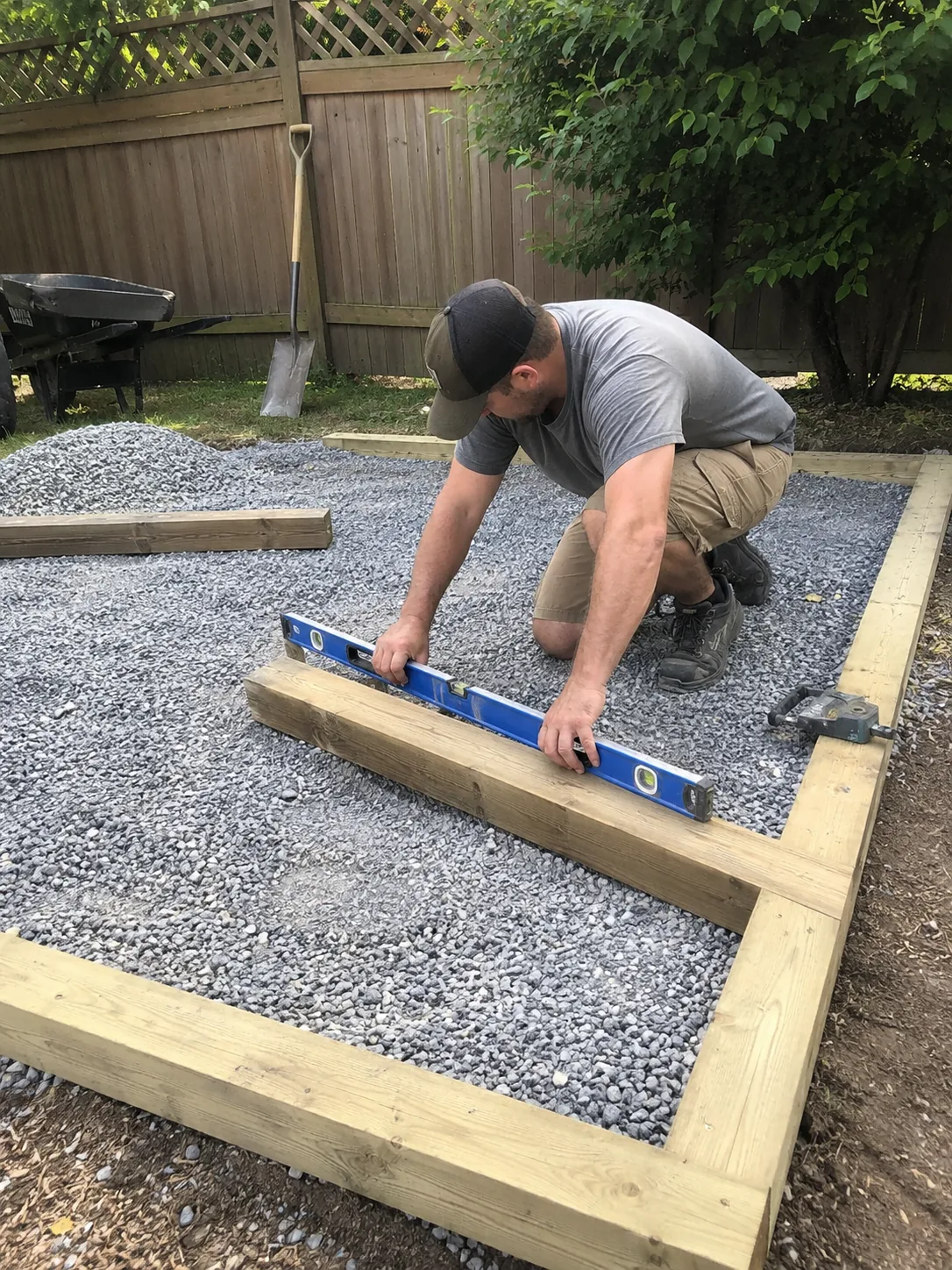 Shed Builder reviewing placement and drainage options in a Magnolia - TX backyard before construction, Shed Builder leveling a foundation pad on a Dobbins - TX property before framing work