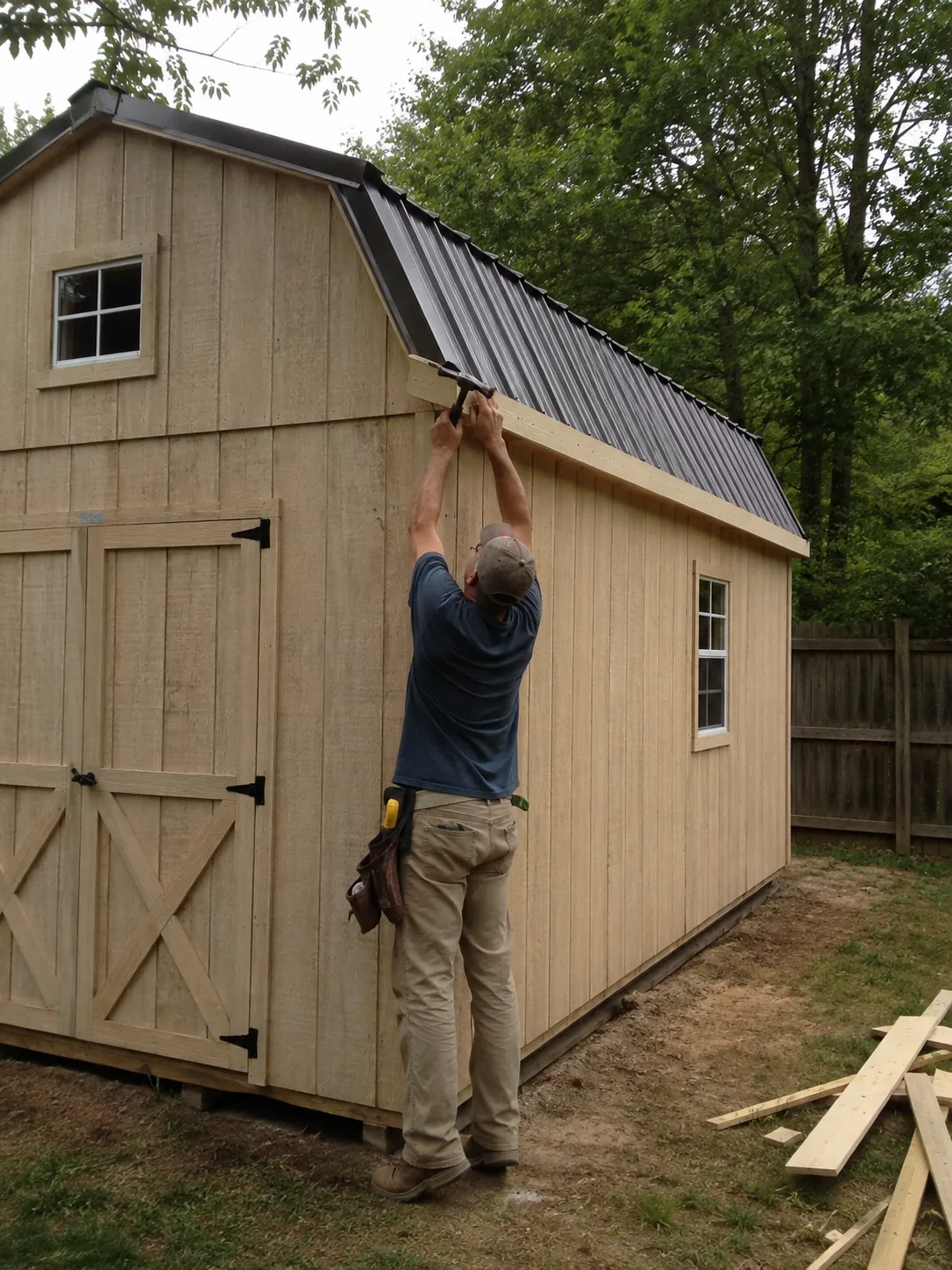 Shed Builder in Spring - TX measuring a backyard corner for a new custom storage shed, Shed Builder in Huntsville - TX measuring a backyard pad before starting shed construction